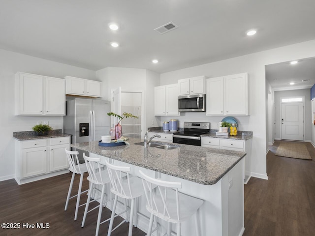 112 Edgewater Way Unit 57, Surf City, NC 28445 - kitchen with appliances with stainless steel finishes, dark wood finished floors, white cabinetry, and recessed lighting