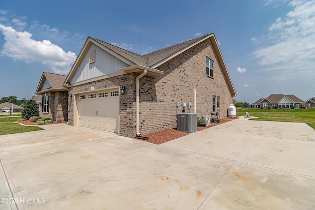 112 Mergini Dr, Pikeville, NC 27863 - view of side of property featuring concrete driveway, brick siding, an attached garage, a yard, and a shingled roof