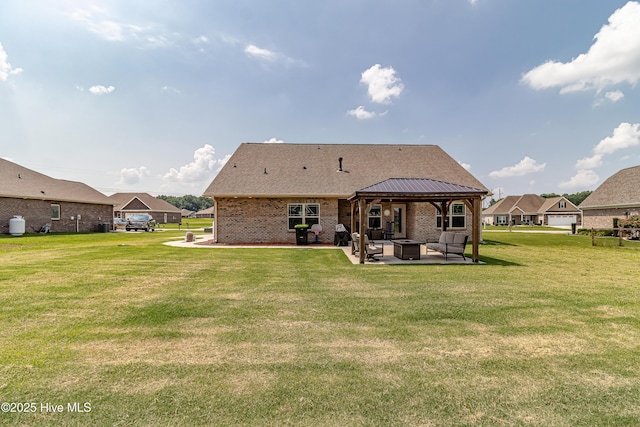112 Mergini Dr, Pikeville, NC 27863 - back of property featuring a gazebo, a patio area, a lawn, brick siding, and an outdoor living space