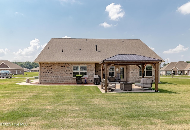 112 Mergini Dr, Pikeville, NC 27863 - back of house featuring a gazebo, a patio area, a yard, brick siding, and roof with shingles