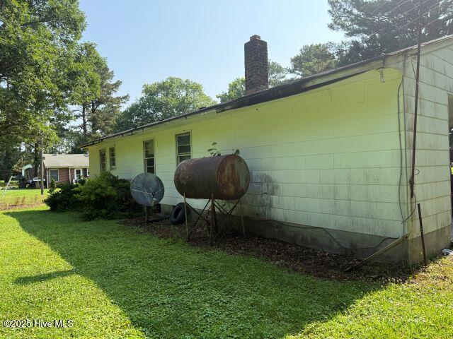 120 Bazemore Ln, Sunbury, NC 27979 - view of property exterior featuring a yard and a chimney