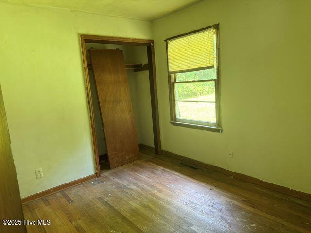 120 Bazemore Ln, Sunbury, NC 27979 - unfurnished bedroom featuring wood finished floors and a closet