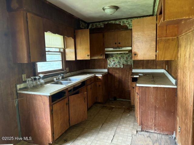 120 Bazemore Ln, Sunbury, NC 27979 - kitchen with under cabinet range hood, brown cabinets, and light countertops