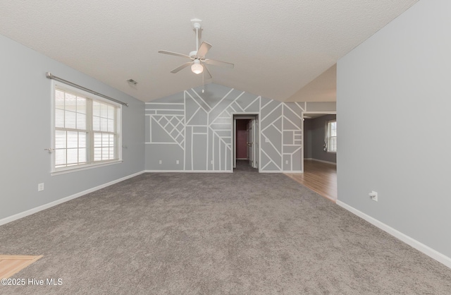 6723 Newbury Way, Wilmington, NC 28411 - carpeted empty room with a ceiling fan, vaulted ceiling, and a textured ceiling