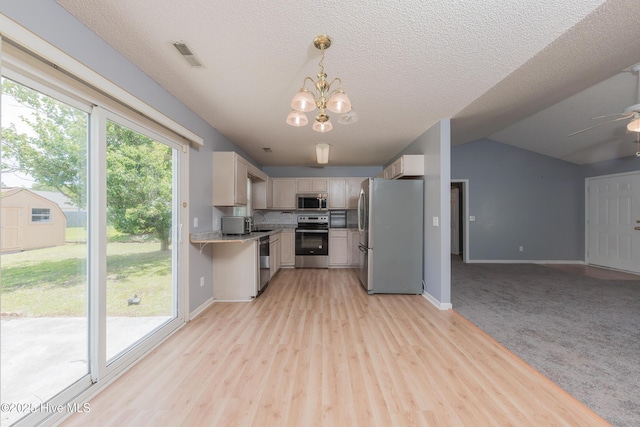 6723 Newbury Way, Wilmington, NC 28411 - kitchen featuring appliances with stainless steel finishes, light countertops, open floor plan, a chandelier, and a ceiling fan