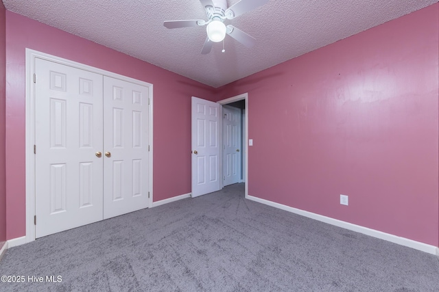 6723 Newbury Way, Wilmington, NC 28411 - unfurnished bedroom with a textured ceiling, carpet flooring, a closet, and a ceiling fan