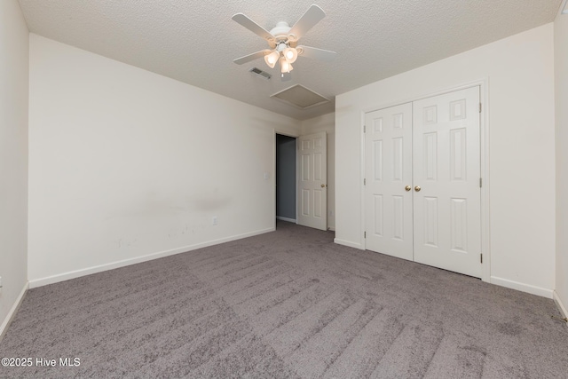 6723 Newbury Way, Wilmington, NC 28411 - unfurnished bedroom featuring attic access, carpet floors, a closet, a textured ceiling, and a ceiling fan