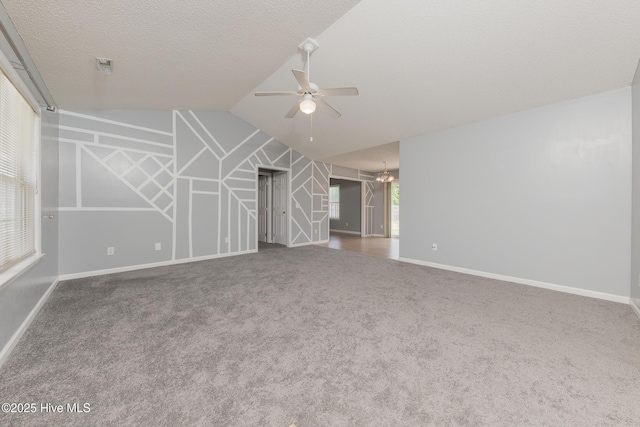 6723 Newbury Way, Wilmington, NC 28411 - unfurnished living room featuring a ceiling fan, vaulted ceiling, carpet, and a textured ceiling