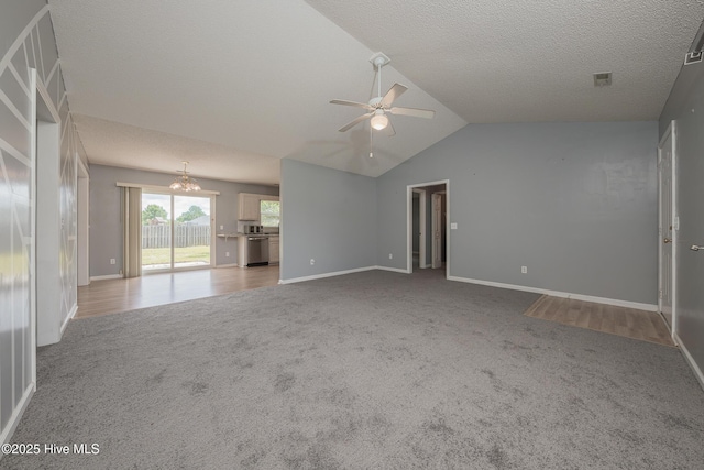6723 Newbury Way, Wilmington, NC 28411 - unfurnished living room with a ceiling fan, carpet, vaulted ceiling, and a textured ceiling