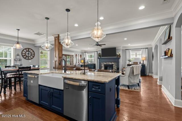 400 Lanyard Dr, Newport, NC 28570 - kitchen featuring dishwasher, blue cabinets, ceiling fan, a stone fireplace, and ornamental molding