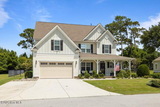 400 Lanyard Dr, Newport, NC 28570 - view of front of house featuring board and batten siding, a porch, a garage, driveway, and roof with shingles