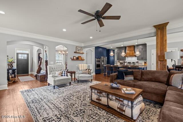400 Lanyard Dr, Newport, NC 28570 - living room with ornamental molding, arched walkways, light wood finished floors, ceiling fan, and recessed lighting