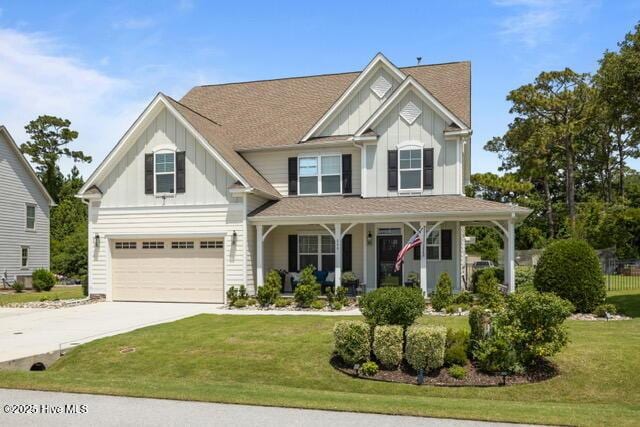 400 Lanyard Dr, Newport, NC 28570 - craftsman inspired home with board and batten siding, a porch, an attached garage, concrete driveway, and a front yard