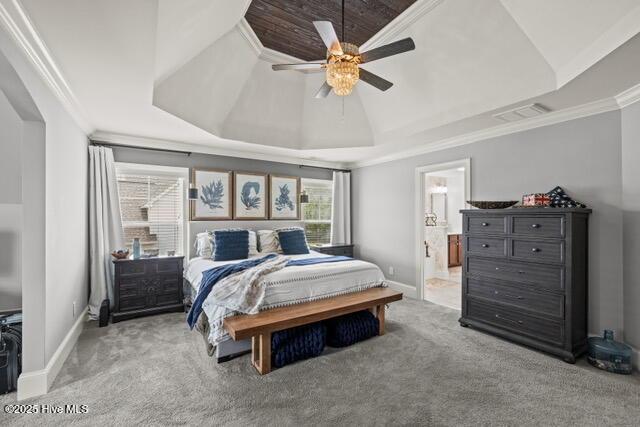 400 Lanyard Dr, Newport, NC 28570 - carpeted bedroom featuring a raised ceiling, ornamental molding, wooden ceiling, ensuite bath, and a ceiling fan