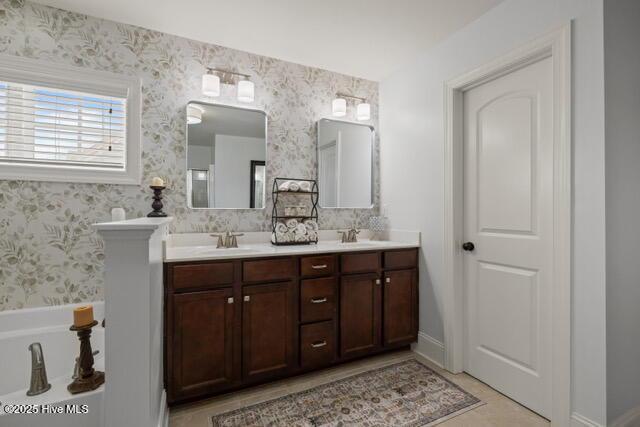 400 Lanyard Dr, Newport, NC 28570 - full bath with double vanity, wallpapered walls, a tub to relax in, and tile patterned flooring