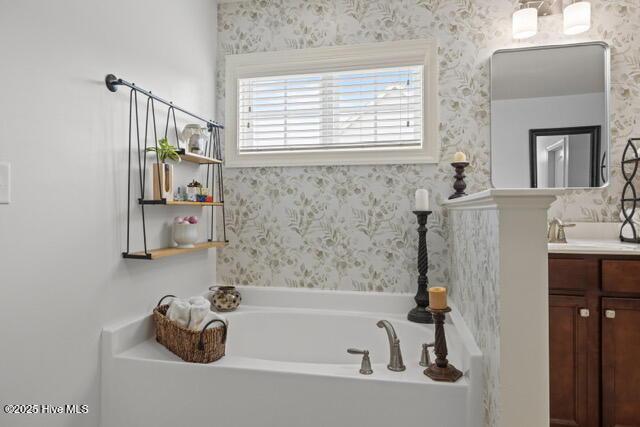 400 Lanyard Dr, Newport, NC 28570 - bathroom with vanity, a garden tub, and wallpapered walls