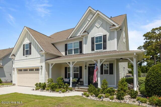 400 Lanyard Dr, Newport, NC 28570 - craftsman-style house featuring board and batten siding, covered porch, a garage, driveway, and a shingled roof