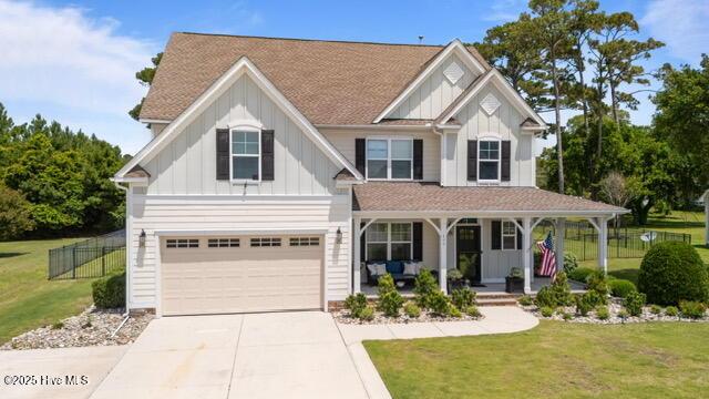 400 Lanyard Dr, Newport, NC 28570 - view of front of property featuring a porch, board and batten siding, concrete driveway, and a garage
