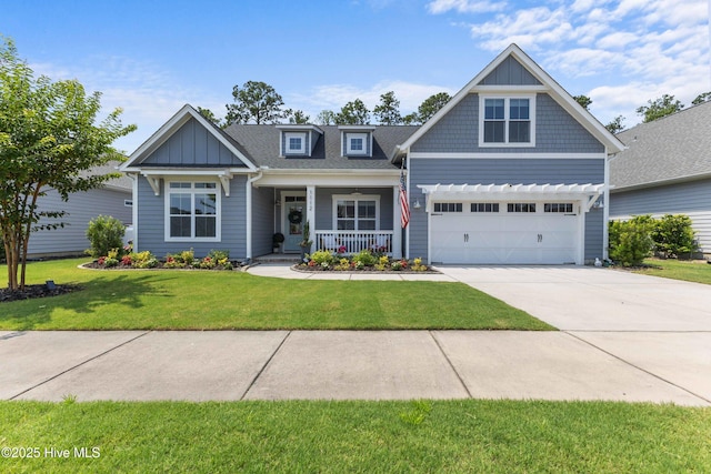 1112 Winged Seed Way, Wilmington, NC 28409 - craftsman house with covered porch, concrete driveway, a front yard, board and batten siding, and a garage