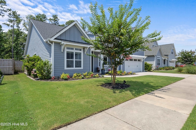 1112 Winged Seed Way, Wilmington, NC 28409 - view of front of house featuring driveway, board and batten siding, an attached garage, and a shingled roof