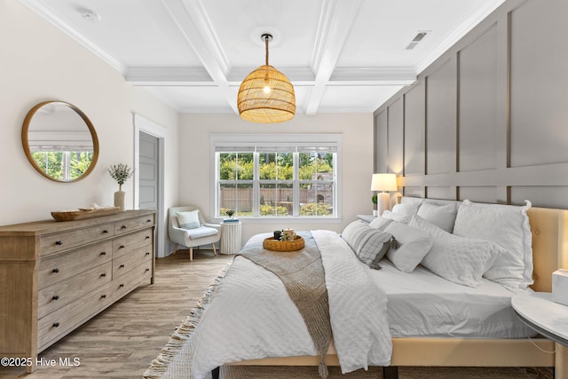 1112 Winged Seed Way, Wilmington, NC 28409 - bedroom featuring light wood-type flooring, beamed ceiling, coffered ceiling, and ornamental molding