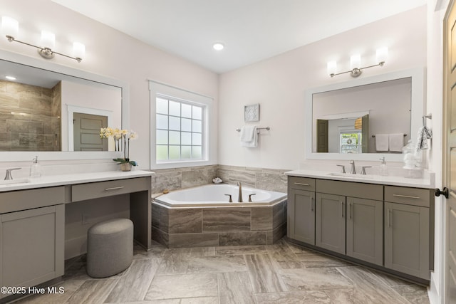 1112 Winged Seed Way, Wilmington, NC 28409 - bathroom featuring two vanities, a garden tub, marble finish flooring, and a tile shower