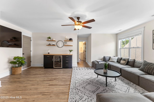 1112 Winged Seed Way, Wilmington, NC 28409 - living room featuring a dry bar, light wood finished floors, a ceiling fan, and wine cooler