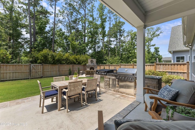 1112 Winged Seed Way, Wilmington, NC 28409 - fenced backyard with area for grilling, a patio, and outdoor dining area