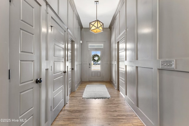 1112 Winged Seed Way, Wilmington, NC 28409 - doorway with a decorative wall and light wood-style flooring
