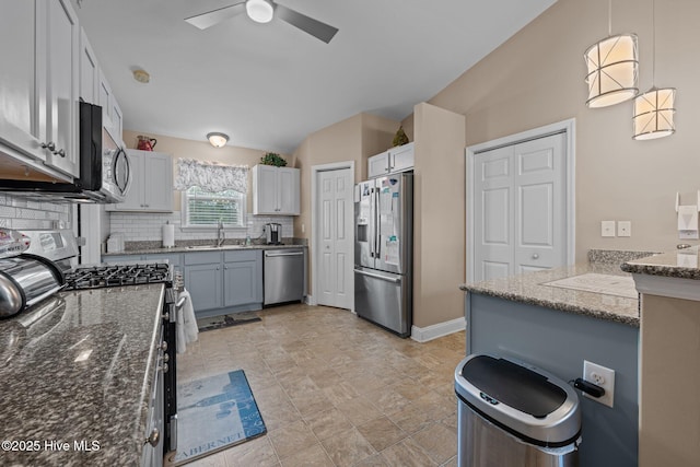 102 Bandon Dr, New Bern, NC 28562 - kitchen with appliances with stainless steel finishes, dark stone countertops, decorative backsplash, lofted ceiling, and ceiling fan
