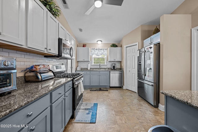 102 Bandon Dr, New Bern, NC 28562 - kitchen with appliances with stainless steel finishes, tasteful backsplash, a ceiling fan, dark stone counters, and gray cabinets