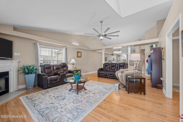 102 Bandon Dr, New Bern, NC 28562 - living room featuring ceiling fan, lofted ceiling, light wood-type flooring, a fireplace with flush hearth, and a chandelier