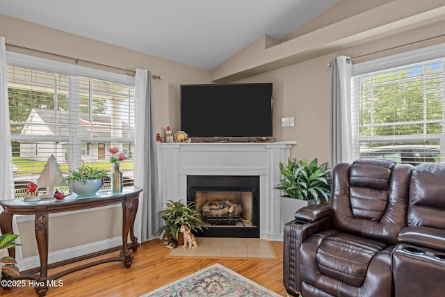102 Bandon Dr, New Bern, NC 28562 - living room with vaulted ceiling, light wood-type flooring, and a fireplace with flush hearth