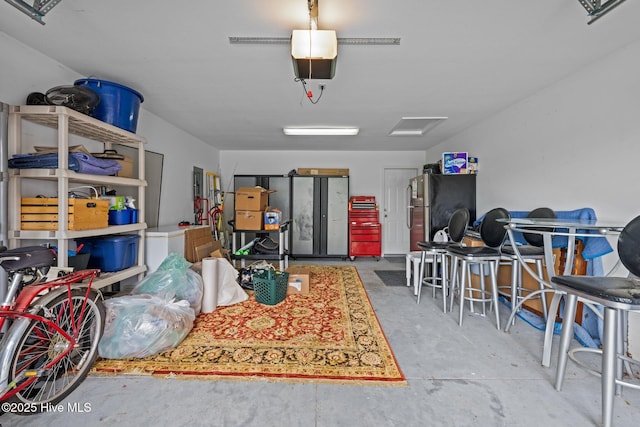 102 Bandon Dr, New Bern, NC 28562 - garage featuring freestanding refrigerator and a garage door opener