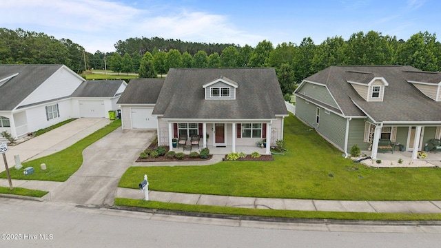 102 Bandon Dr, New Bern, NC 28562 - cape cod house with a porch, driveway, a front lawn, and a garage