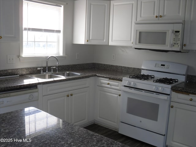 124 Pella Ln, New Bern, NC 28562 - kitchen featuring white appliances, dark countertops, and white cabinets