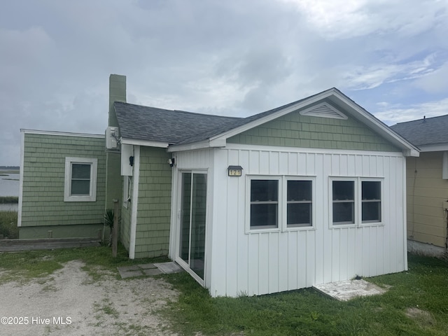 121 Cedar Point Blvd, Cedar Point, NC 28584 - rear view of property featuring a chimney, a shingled roof, and board and batten siding
