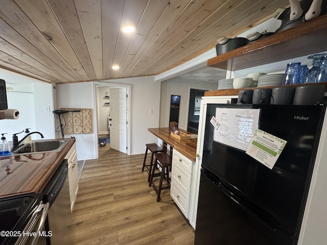 121 Cedar Point Blvd, Cedar Point, NC 28584 - kitchen with appliances with stainless steel finishes, wood counters, light wood-type flooring, white cabinets, and open shelves