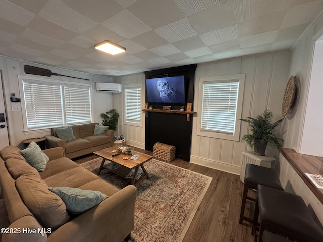 121 Cedar Point Blvd, Cedar Point, NC 28584 - living area featuring a wall unit AC, wood finished floors, and plenty of natural light