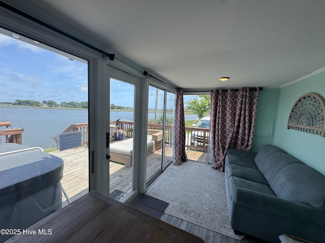 123 Cedar Point Blvd, Cedar Point, NC 28584 - living room featuring a water view, wood finished floors, and ornamental molding