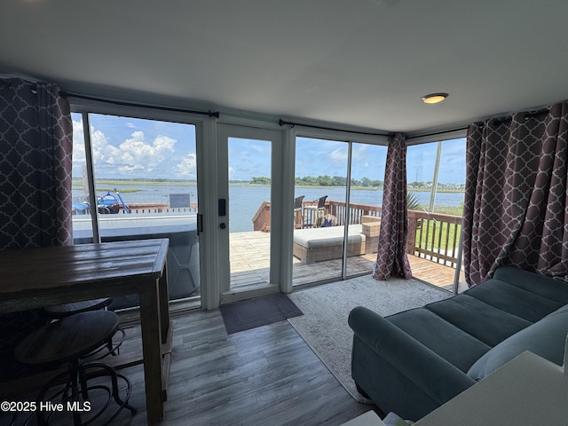 123 Cedar Point Blvd, Cedar Point, NC 28584 - living room featuring a water view, wood finished floors, and healthy amount of natural light