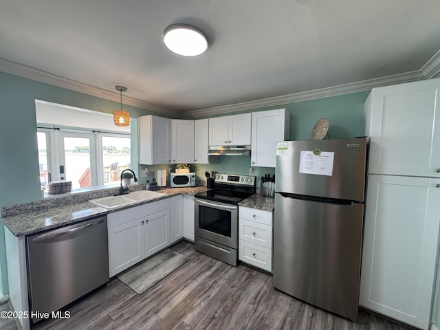 123 Cedar Point Blvd, Cedar Point, NC 28584 - kitchen featuring stainless steel appliances, under cabinet range hood, ornamental molding, white cabinets, and dark wood-type flooring