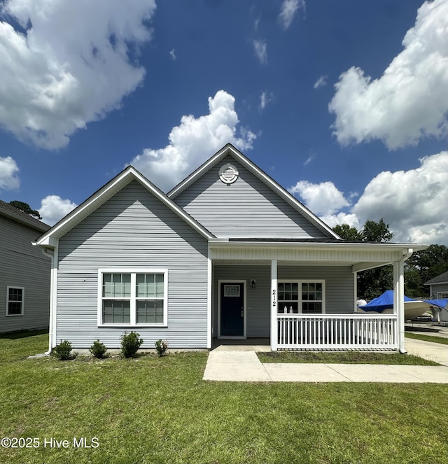 212 Robert Alan Dr, Jacksonville, NC 28546 - view of front of home featuring covered porch and a front lawn