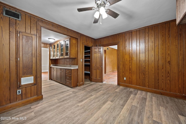 1200 W Lenoir Ave, Kinston, NC 28501 - spare room featuring wood walls, ceiling fan, light wood finished floors, and ornamental molding