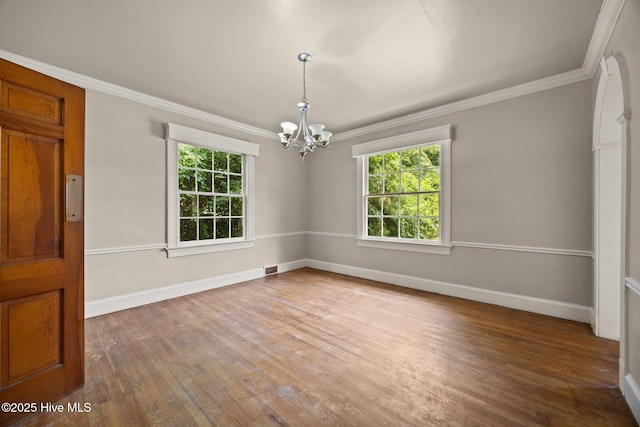 1200 W Lenoir Ave, Kinston, NC 28501 - spare room featuring plenty of natural light, a chandelier, wood finished floors, and crown molding