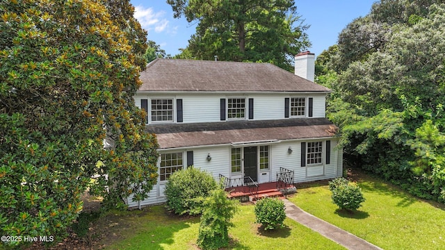1200 W Lenoir Ave, Kinston, NC 28501 - view of front of home with a chimney, a front lawn, a wooden deck, and a shingled roof