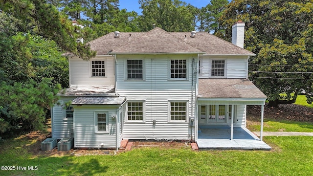 1200 W Lenoir Ave, Kinston, NC 28501 - back of property featuring a patio, a chimney, a yard, and roof with shingles