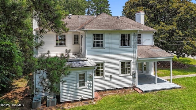 1200 W Lenoir Ave, Kinston, NC 28501 - back of property with a patio, a chimney, and a yard