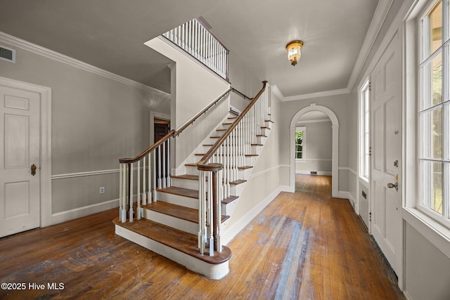 1200 W Lenoir Ave, Kinston, NC 28501 - entryway featuring arched walkways, wood-type flooring, stairway, and crown molding
