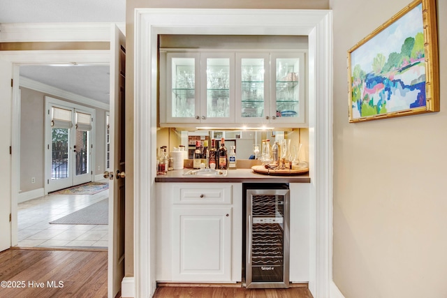 3509 Lakeview Trl, Kinston, NC 28504 - indoor dry bar featuring wine cooler, crown molding, and light wood-type flooring